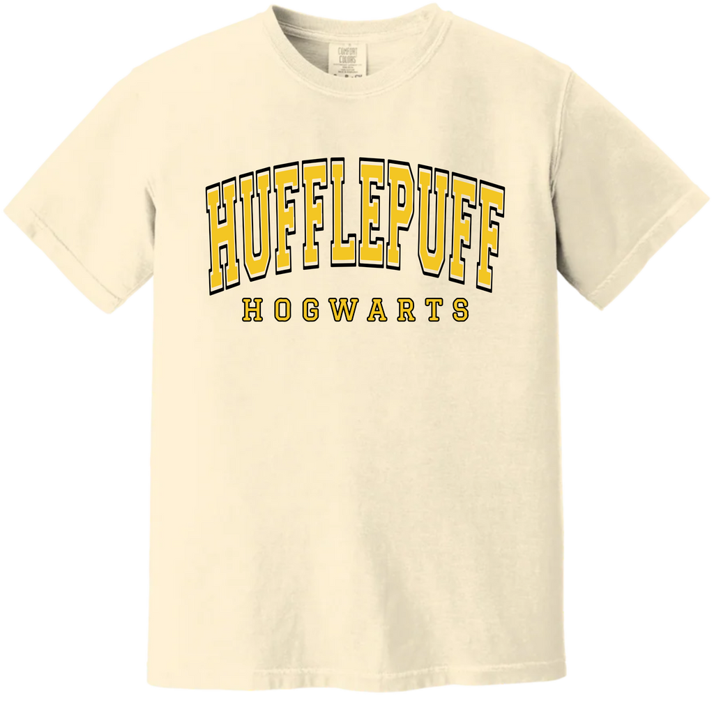 Beige t-shirt with 'Hufflepuff Hogwarts' text in yellow and black on a white background