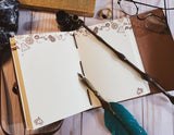 Open notebook with decorative pen and wand on a wooden surface